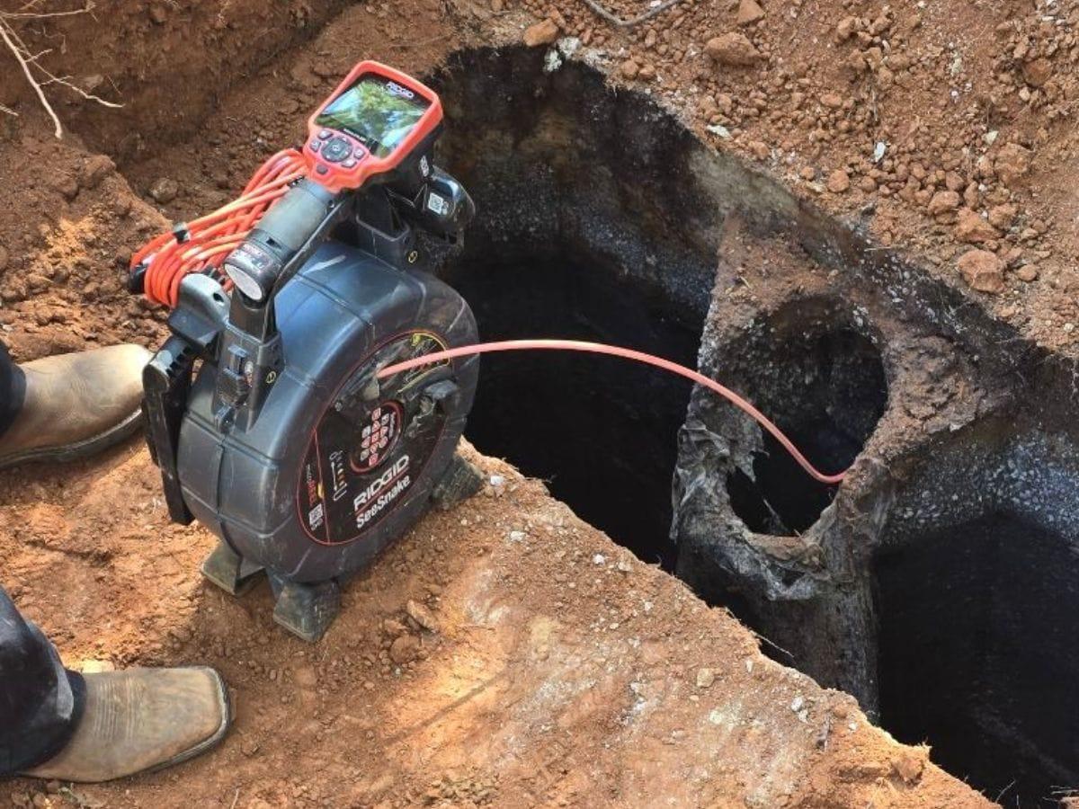 Septic line camera inspection equipment at an open tank